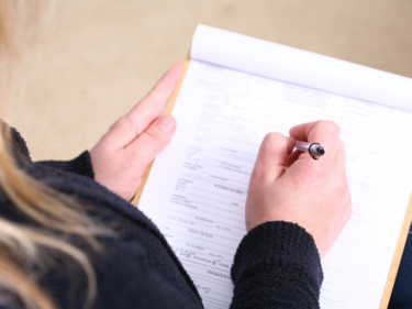 Blonde woman filling out forms