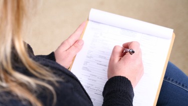 Blonde woman filling out forms