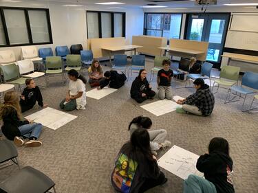 Group of students gathered on the floor